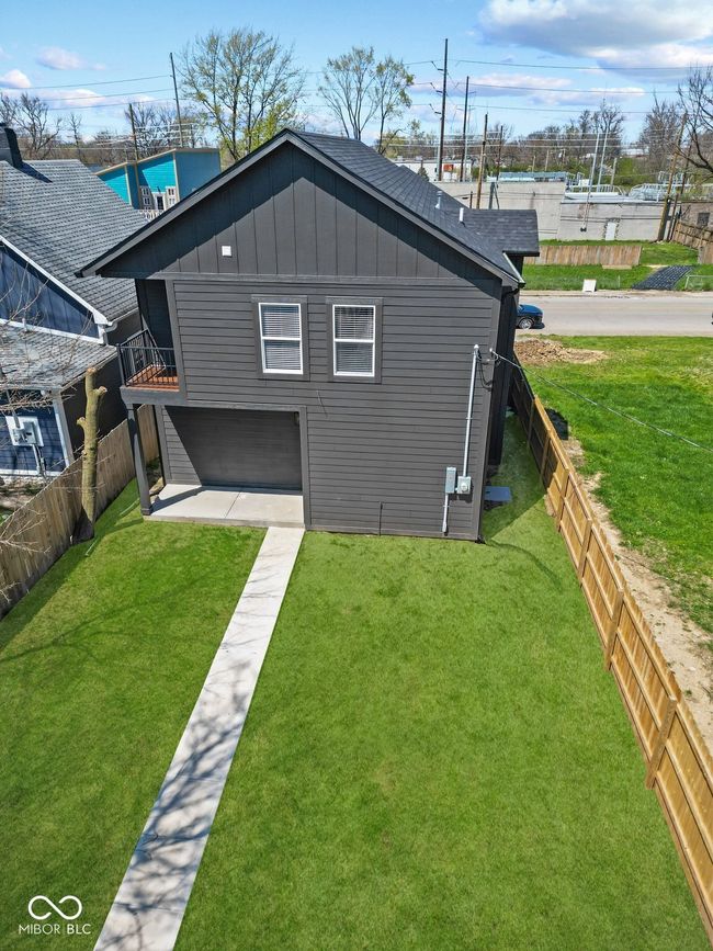 rear view of property with a patio, fenced backyard, a yard, and board and batten siding | Image 35