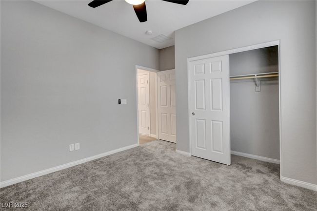 Unfurnished bedroom featuring carpet, a closet, baseboards, and a ceiling fan | Image 13