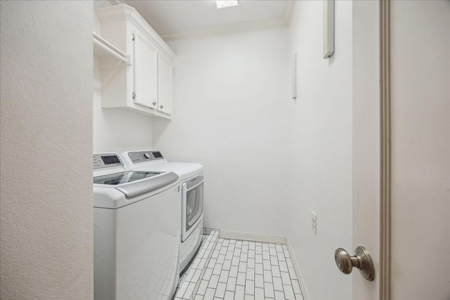 Nice sized laundry too with recent tile and plenty of storage. | Image 27