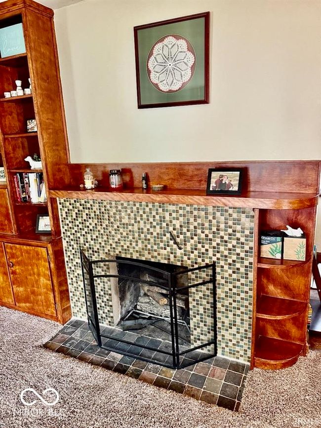 detailed view of carpet floors and a fireplace | Image 12