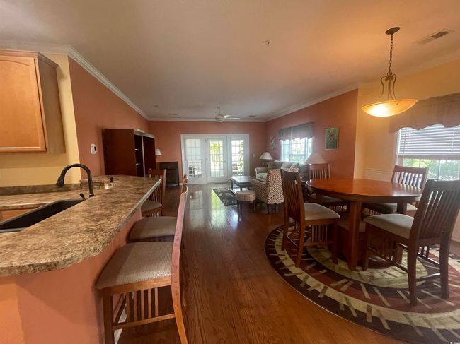 Dining Area with Crown Molding, Hardwood Floors, and an Abundant Amount of Natural Sunlight | Image 5