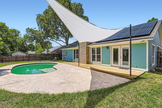 View of swimming pool with french doors, a deck, and a fenced backyard | Image 21
