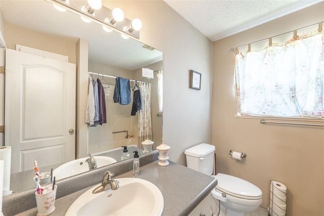 Full bath with vanity, toilet, and a textured ceiling | Image 23