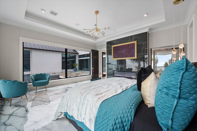 Bedroom with an inviting chandelier, visible vents, marble finish floor, recessed lighting, and a tray ceiling | Image 15