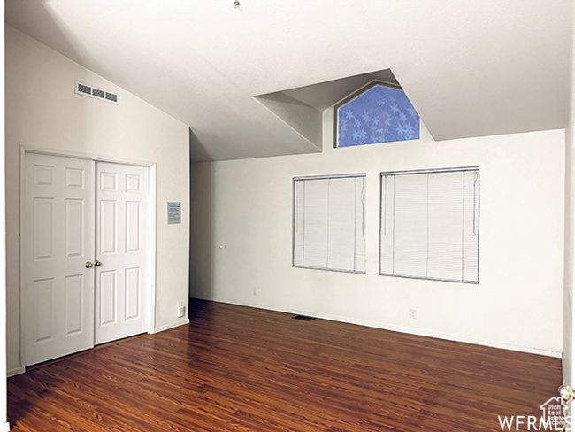Interior space featuring vaulted ceiling, visible vents, and wood finished floors | Image 6
