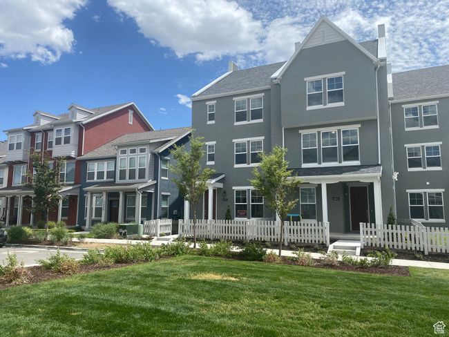 View of front facade featuring a chimney, stucco siding, and covered porch | Image 27