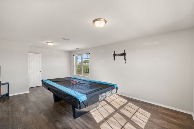 Recreation room with baseboards, visible vents, pool table, and wood finished floors | Image 8