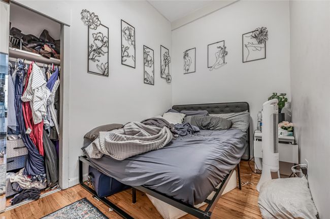 Bedroom featuring wood finished floors and a closet | Image 10