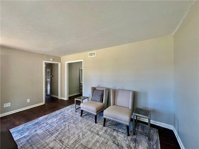 Living area with a textured ceiling and hardwood / wood-style flooring | Image 3