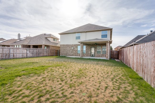 Rear view of house with ceiling fan, a patio area, and a yard | Image 27