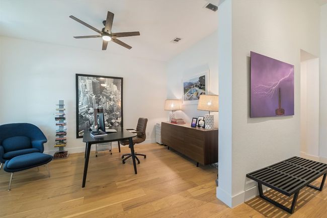 Office space featuring light wood-style floors, a ceiling fan, and baseboards | Image 14