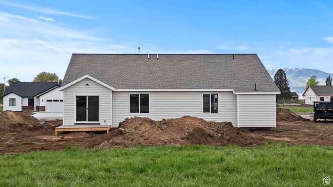 Rear view of property with a shingled roof and a mountain view | Image 25