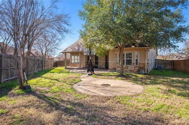 Back of property with a patio, stucco siding, a fenced backyard, and stone siding | Image 29