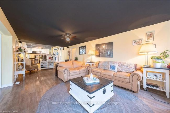 Living room with hardwood / wood-style floors and ceiling fan | Image 20