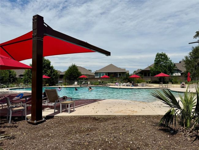 Large swimming pool with plenty of shade covered seating and restrooms. Planned activities. | Image 33