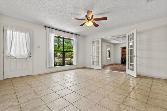 This cozy den sits just off the eat-in kitchen, making it a great spot to relax while staying connected to the main living areas. | Image 8