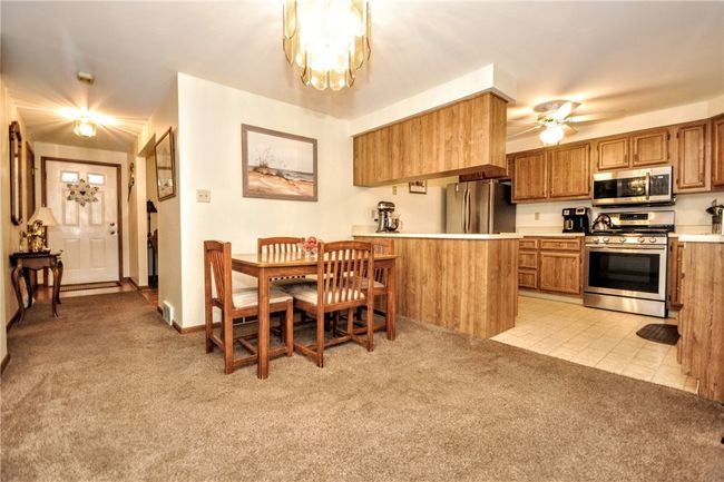 Another view of the dining room and the kitchen and showing the front entryway with the bedrooms being off to the left | Image 23