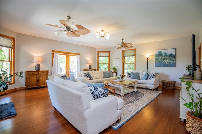 This home offers ample living spaces across the multiple levels, this is the main level living room. | Image 6