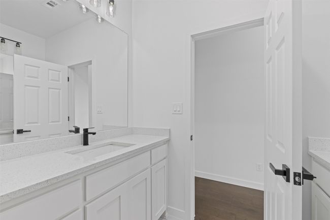 Bathroom with vanity, baseboards, wood finished floors, and visible vents | Image 33