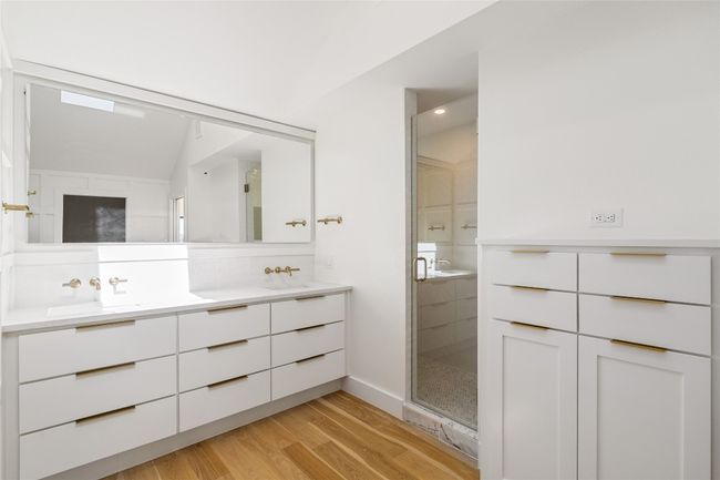 Primary bathroom with dual vanity and walk in shower | Image 16