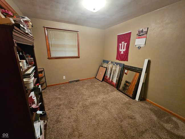 unfurnished bedroom with carpet and baseboards | Image 21