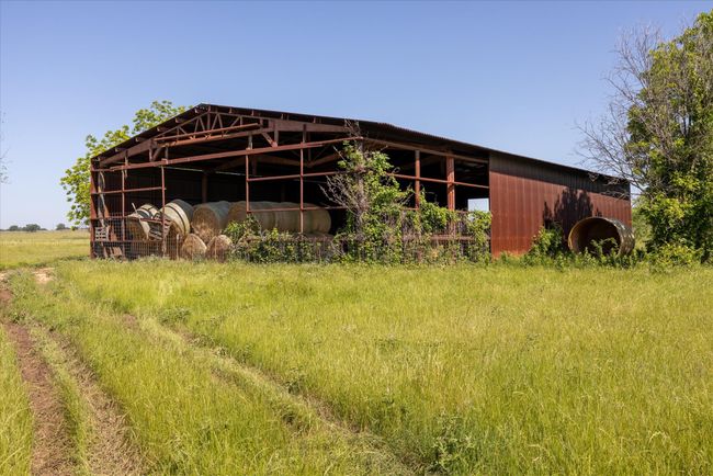 Back side of the barn. There is leftover sheet metal on the property that can be used to finish enclosing the barn. | Image 10