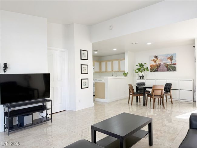 Living area with marble finish floor, baseboards, and recessed lighting | Image 4