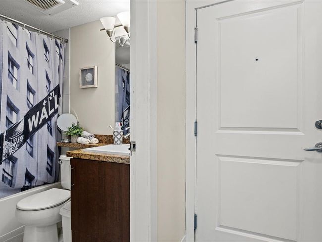 Bathroom featuring vanity, a textured ceiling, and shower / bath combo | Image 12