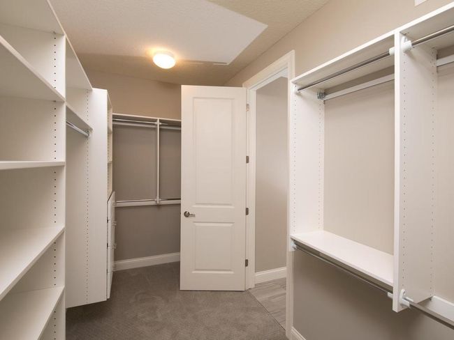 Owners closet with shelving & connects to Laundry room! Photos may not depict actual home plan configuration. Features/materials/finishes shown contain options that are not included. | Image 15