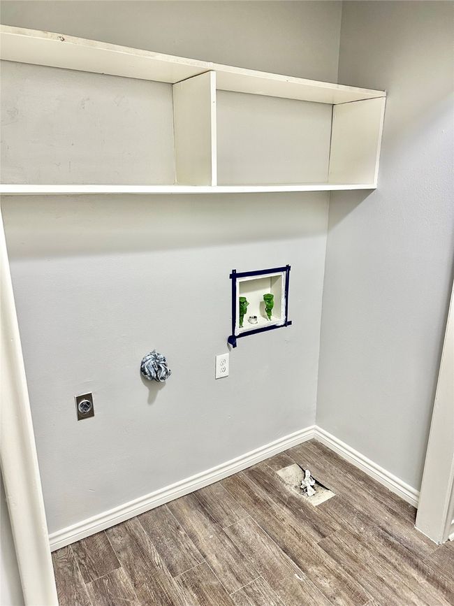 Laundry room featuring hookup for an electric dryer, hookup for a washing machine, and wood finished floors | Image 10