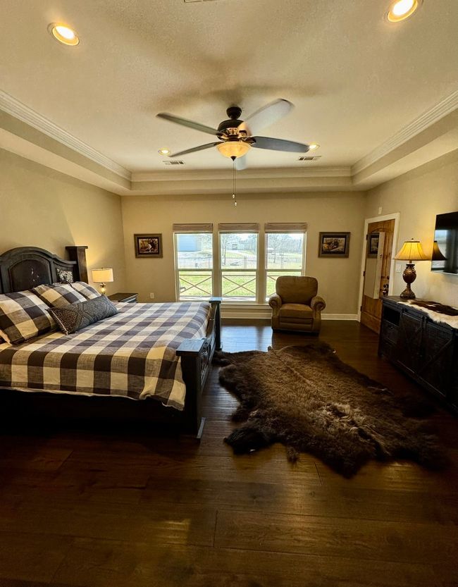 Bedroom featuring visible vents, ornamental molding, and wood-type flooring | Image 13