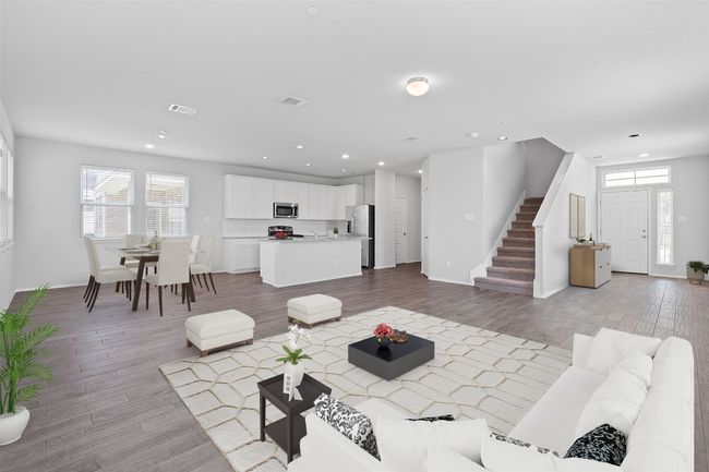 Living room with light wood finished floors, stairway, and recessed lighting | Image 5