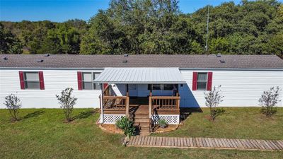 Front View featuring a covered deck and sprawling lawn! | Image 1