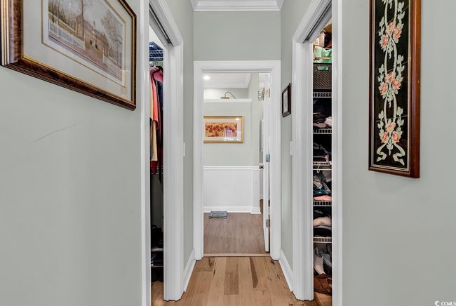 Bedroom featuring crown molding, light hardwood / wood-style flooring, a raised ceiling, and ceiling fan | Image 18