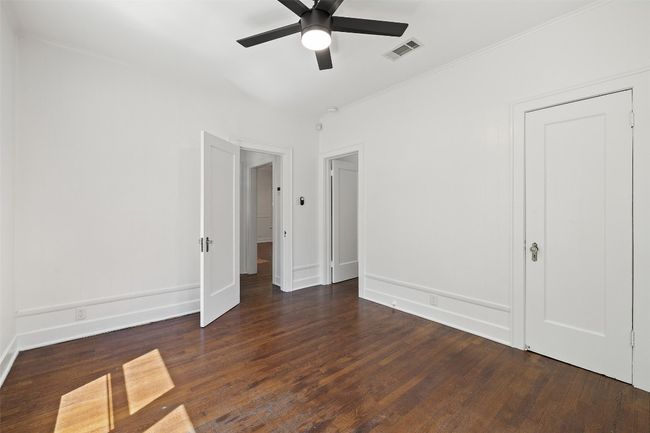 Unfurnished bedroom featuring visible vents, baseboards, and wood finished floors | Image 19