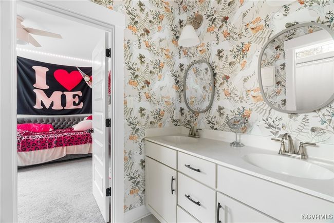 Ensuite bathroom featuring wallpapered walls, double vanity, a ceiling fan, and baseboards | Image 28