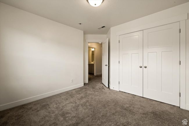 Unfurnished bedroom featuring a closet, carpet floors, visible vents, and baseboards | Image 22