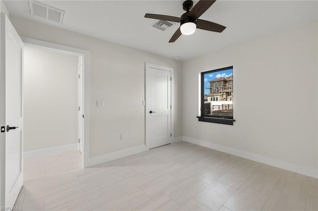 Unfurnished bedroom featuring light tile patterned floors and ceiling fan | Image 30