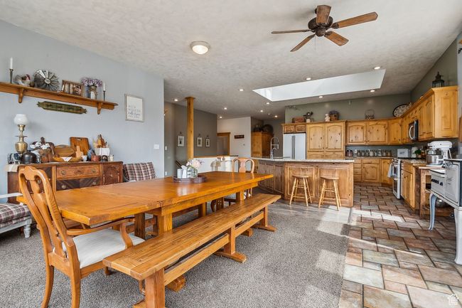 Dining space with a skylight, a ceiling fan, recessed lighting, and a textured ceiling | Image 19