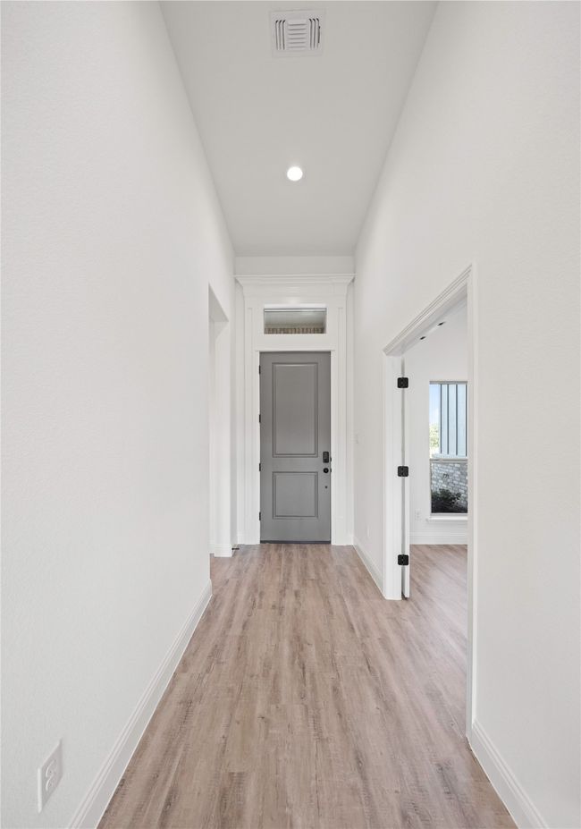 Hall with light wood-type flooring, baseboards, and recessed lighting | Image 4
