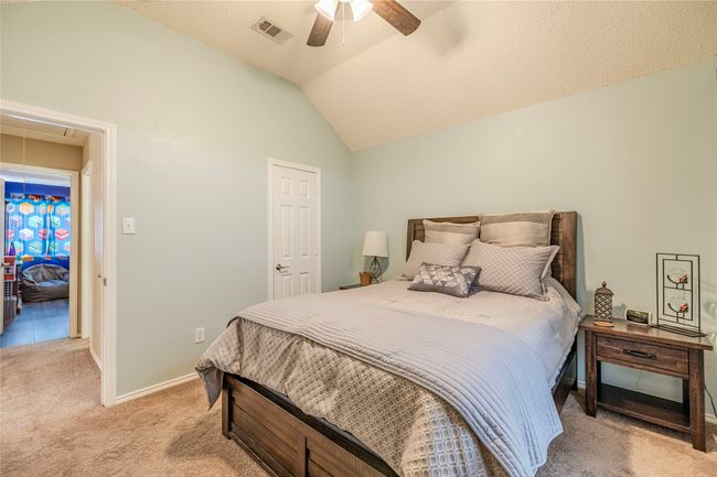 Bedroom with attic access, light carpet, lofted ceiling, a ceiling fan, and baseboards | Image 34