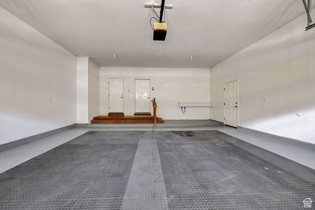Garage with a garage door opener and baseboards | Image 39