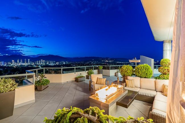 Patio at night featuring an outdoor living space with a fire pit and a balcony | Image 11