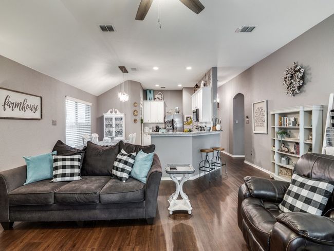Living area featuring arched walkways, dark wood-type flooring, ceiling fan, a chandelier, and recessed lighting | Image 11