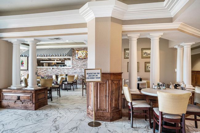Dining space with marble finish flooring and ornamental molding | Image 23