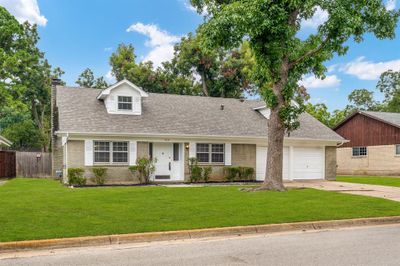 View of front of home featuring a garage and a front lawn | Image 2