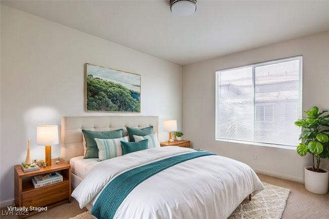 Bedroom featuring light colored carpet and baseboards **VIRTUALLY STAGED** | Image 5