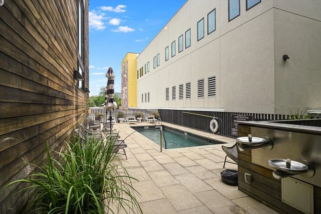 Community pool with fence and a patio area | Image 18
