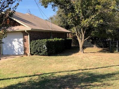 View of home's exterior featuring a yard and a garage | Image 3