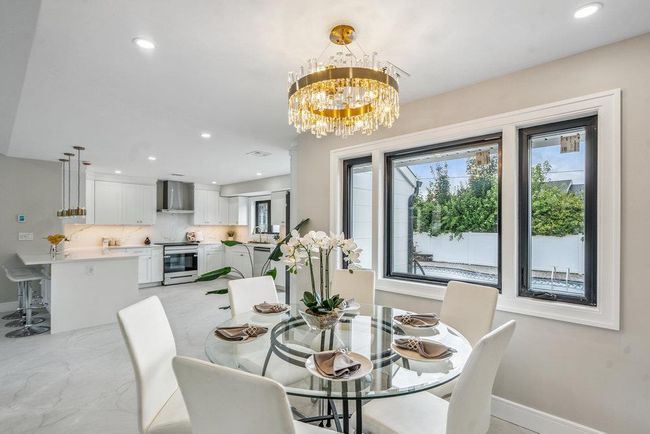 Dining space featuring recessed lighting, and a chandelier | Image 13